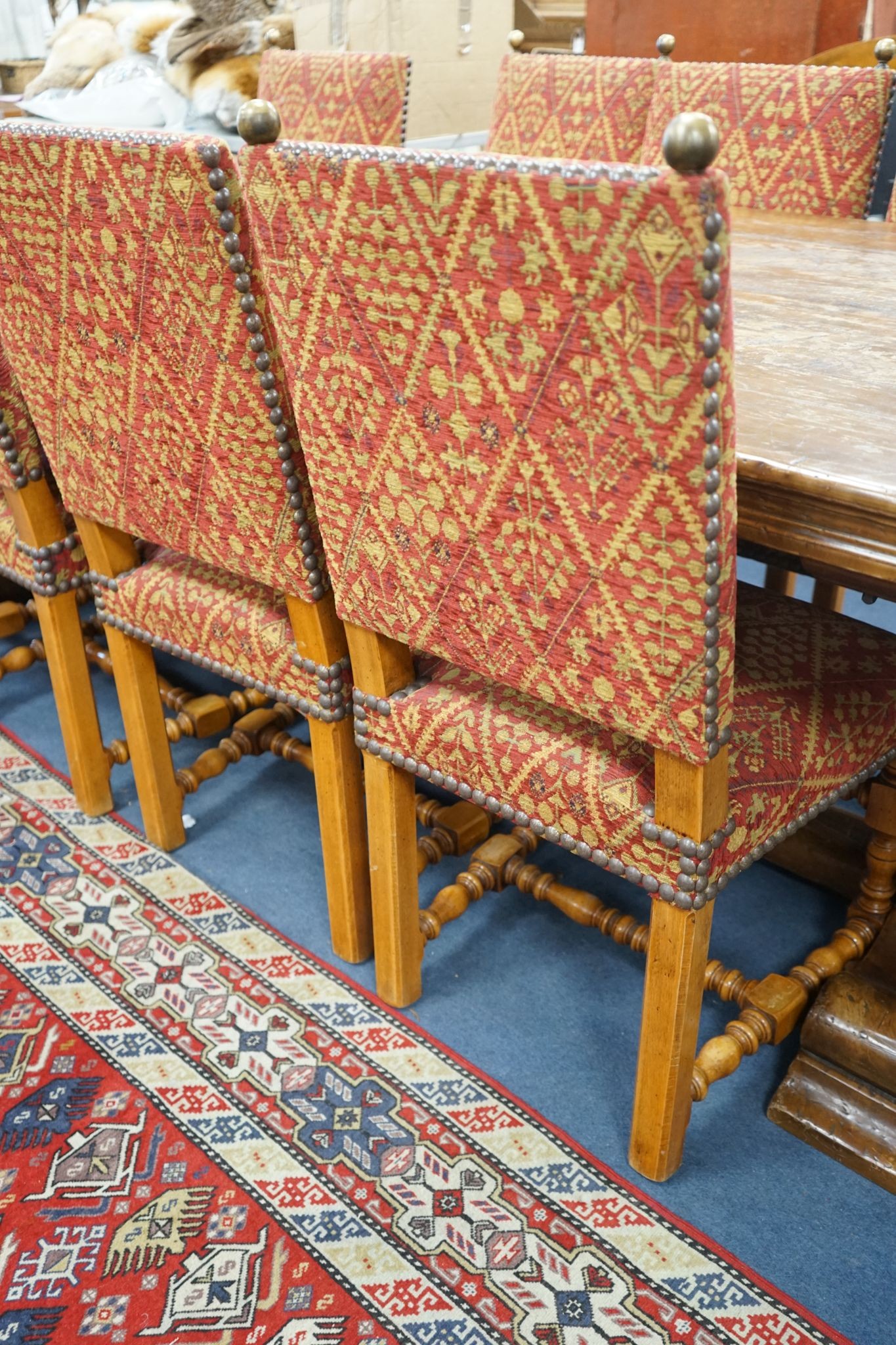 A set of twelve 18th century style French walnut dining chairs on turned underframes with H stretchers